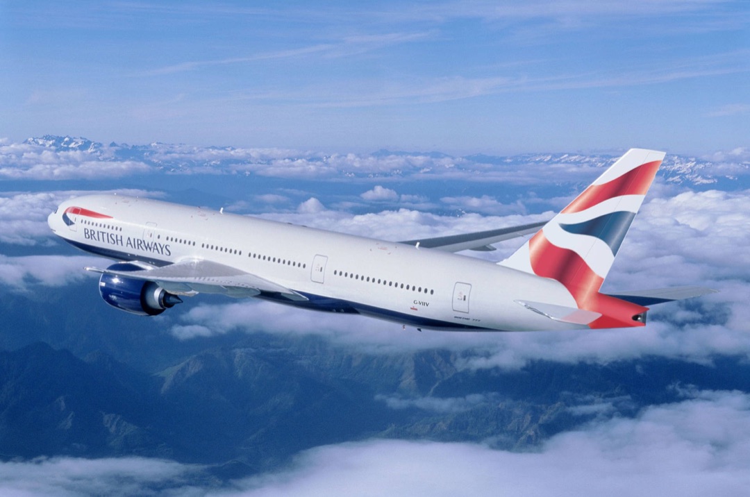 A wide-body passenger jet cruising high above the clouds